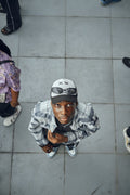 Black man in urban street style wearing a two-tone baseball cap
