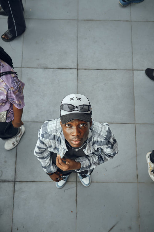 Black man in urban street style wearing a two-tone baseball cap