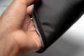 Black smell-proof stash bag unzipped, urban accessory close-up